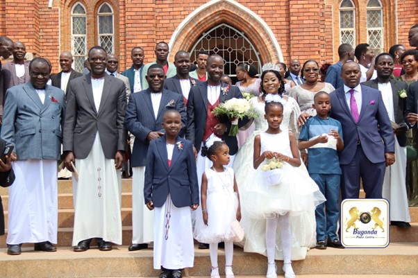 The bride and groom with their guests including the first deputy Katikkiro Image